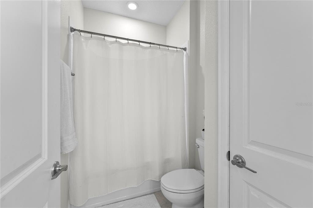 2926 Wordsmith Road Kissimmee, FL 34746 - Photo 9 of 42 a bathroom with a shower curtain
