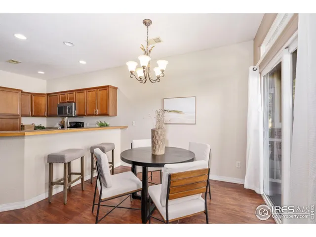 a dining room with kitchen island stainless steel appliances kitchen island a table and chairs
