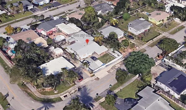 an aerial view of a house with a yard