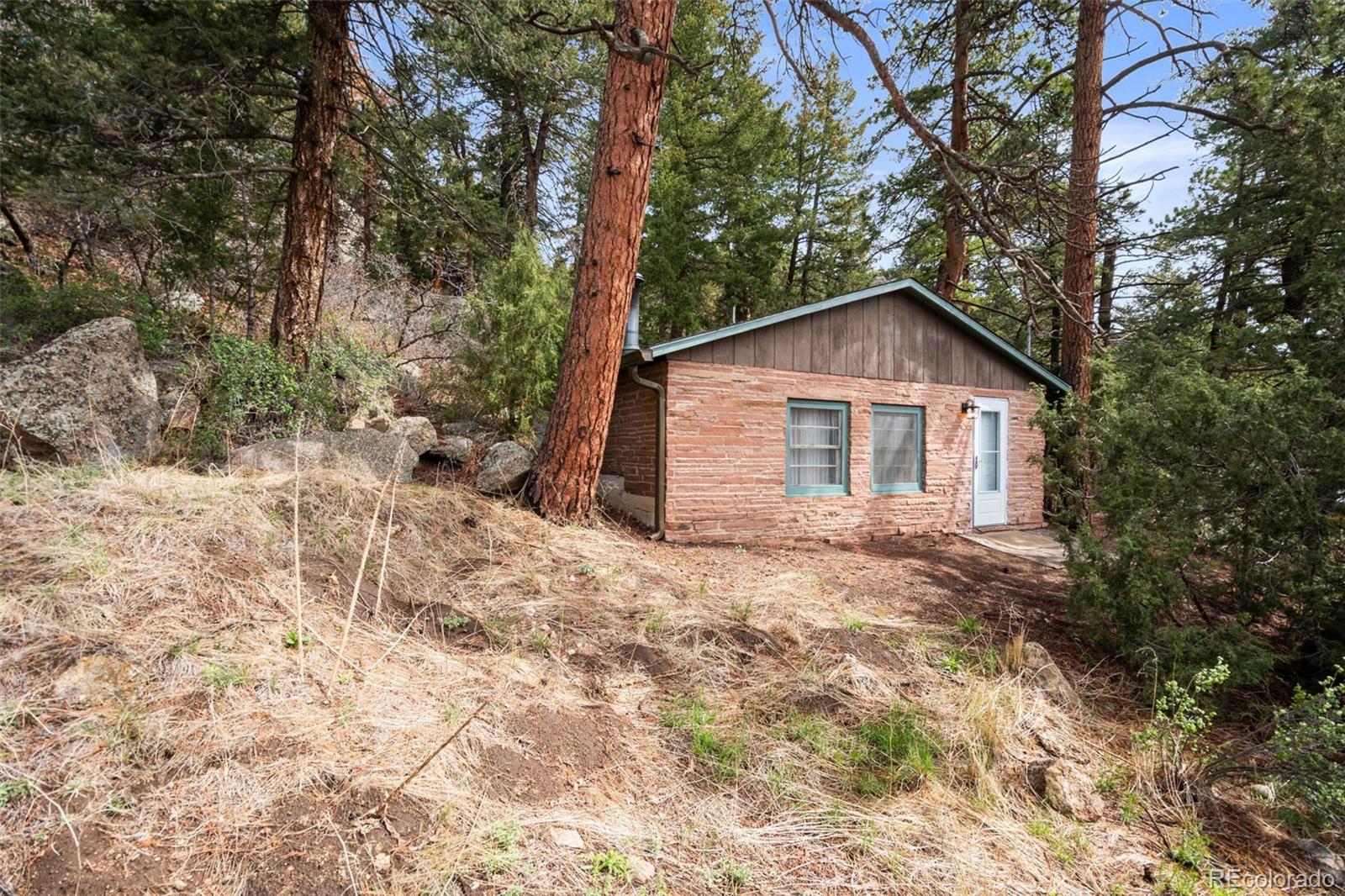 25845 Wilkerson Road Conifer, CO 80433 - Photo 13 of 16 a view of a house with a yard