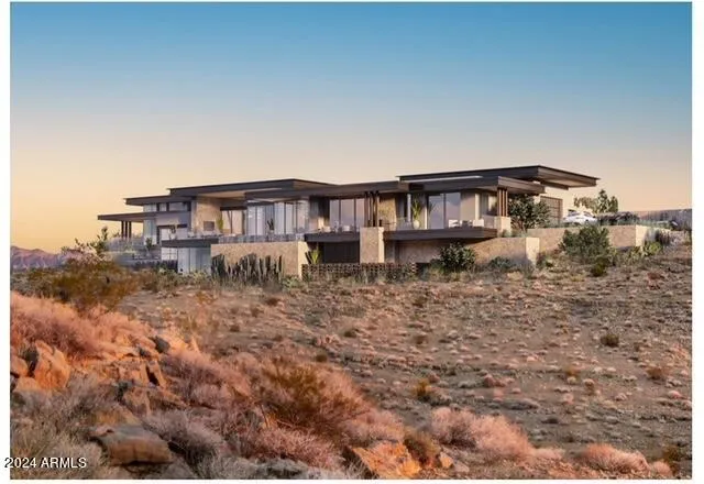 a view of a house with backyard porch and sitting area