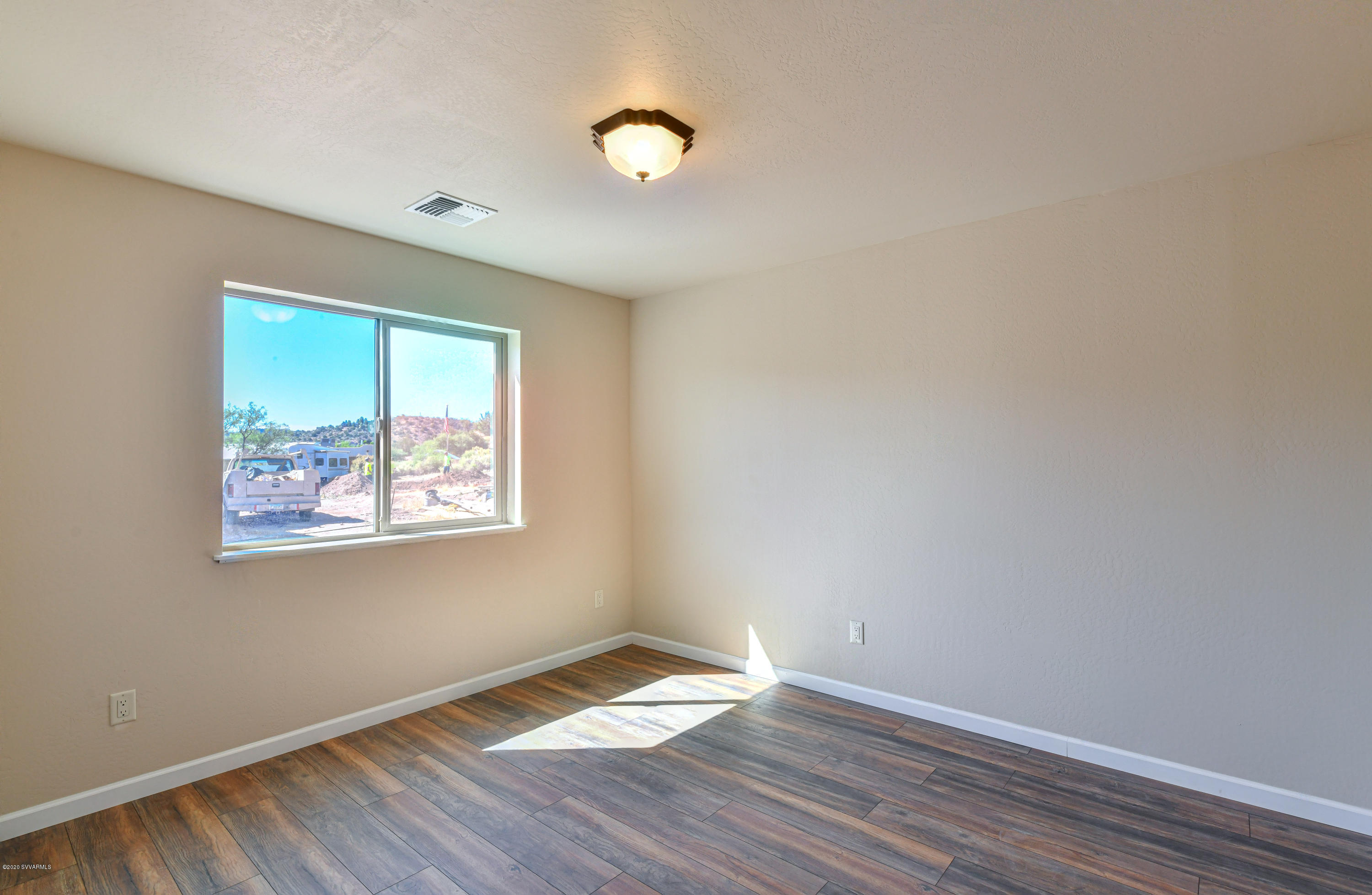 4645 East Goldmine Road Rimrock, AZ 86335 - Photo 17 of 24 an empty room with wooden floor and windows
