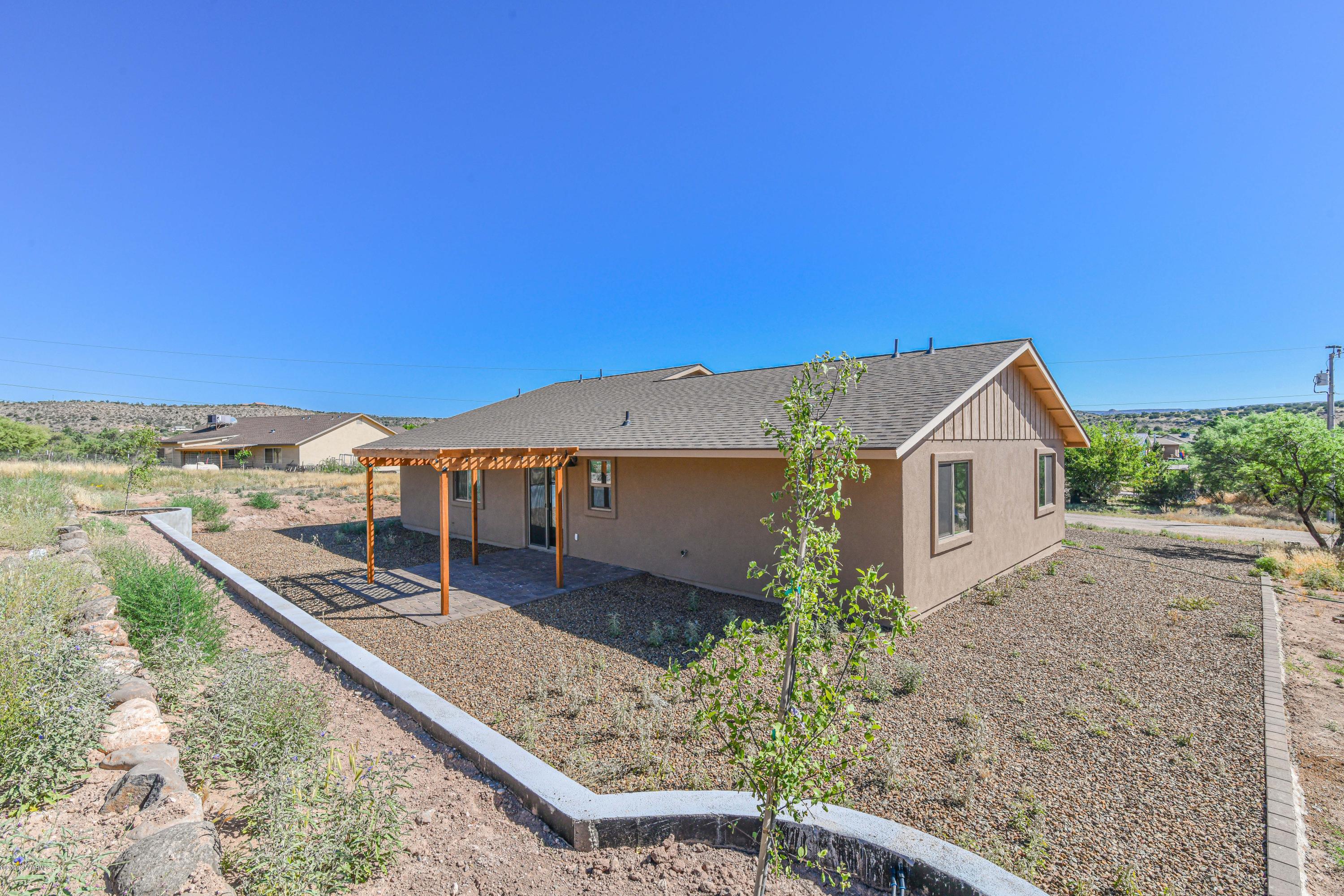 4645 East Goldmine Road Rimrock, AZ 86335 - Photo 23 of 24 a view of a house with a yard and potted plants