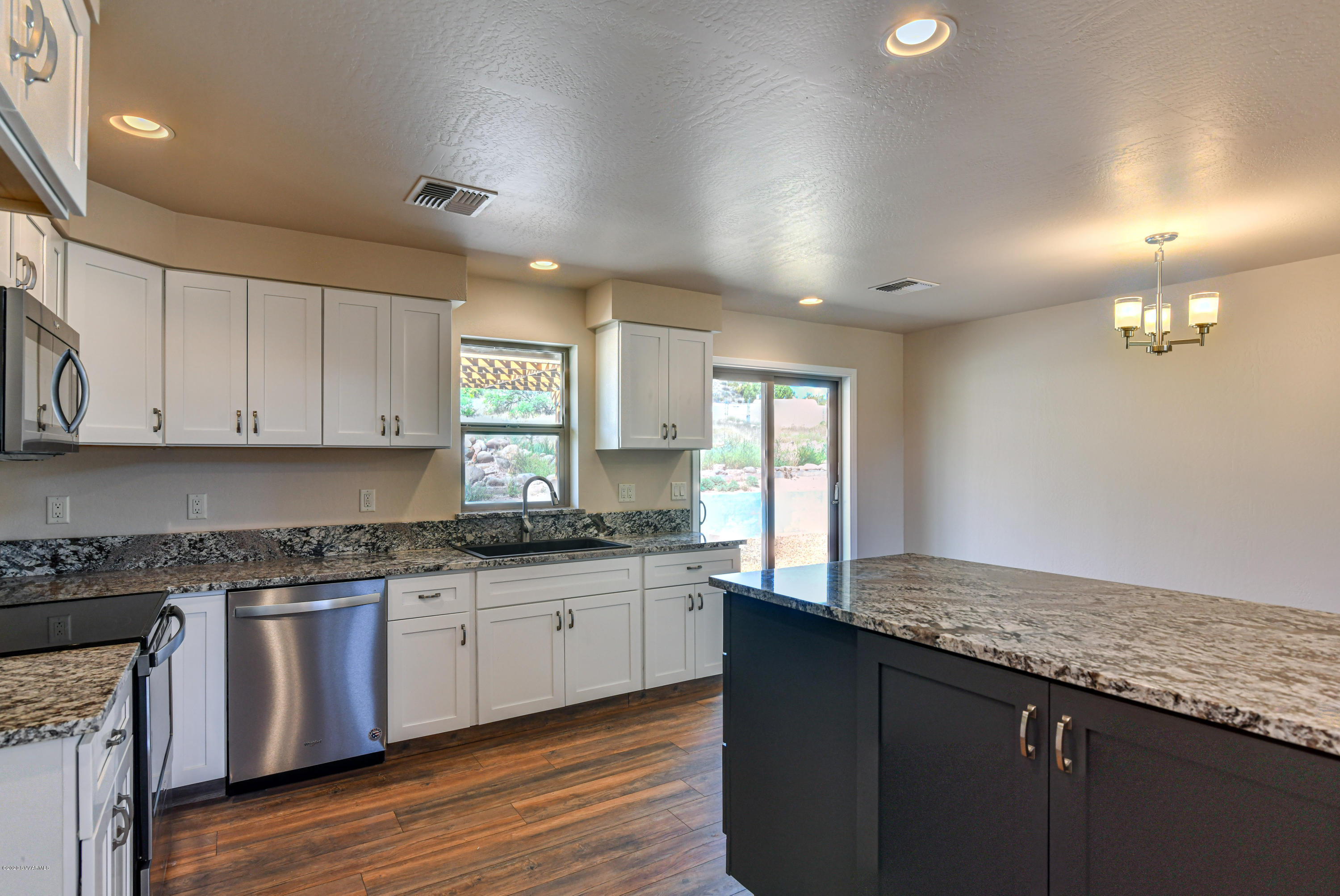 4645 East Goldmine Road Rimrock, AZ 86335 - Photo 4 of 24 a kitchen with granite countertop a sink and cabinets