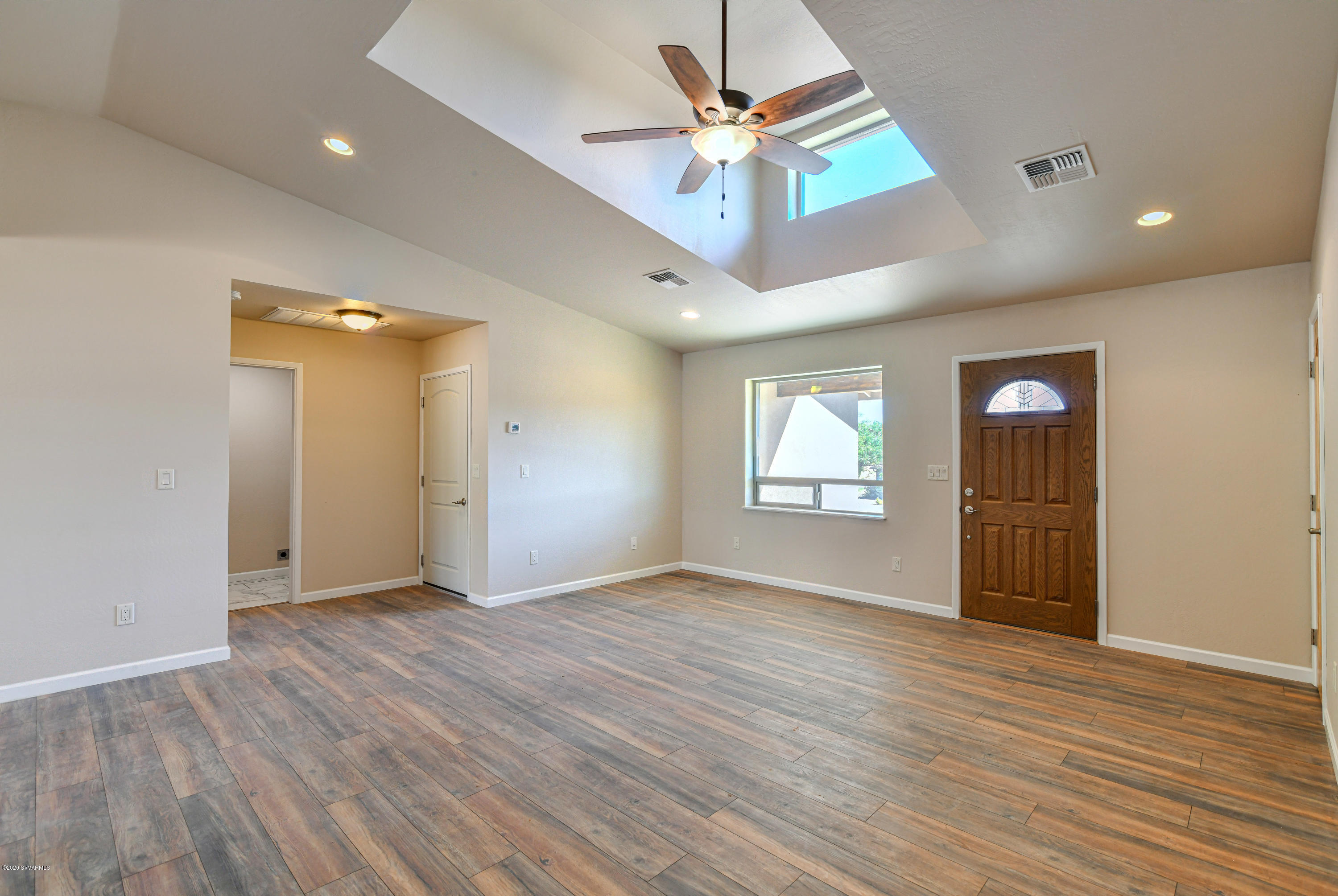 4645 East Goldmine Road Rimrock, AZ 86335 - Photo 6 of 24 an empty room with wooden floor and windows
