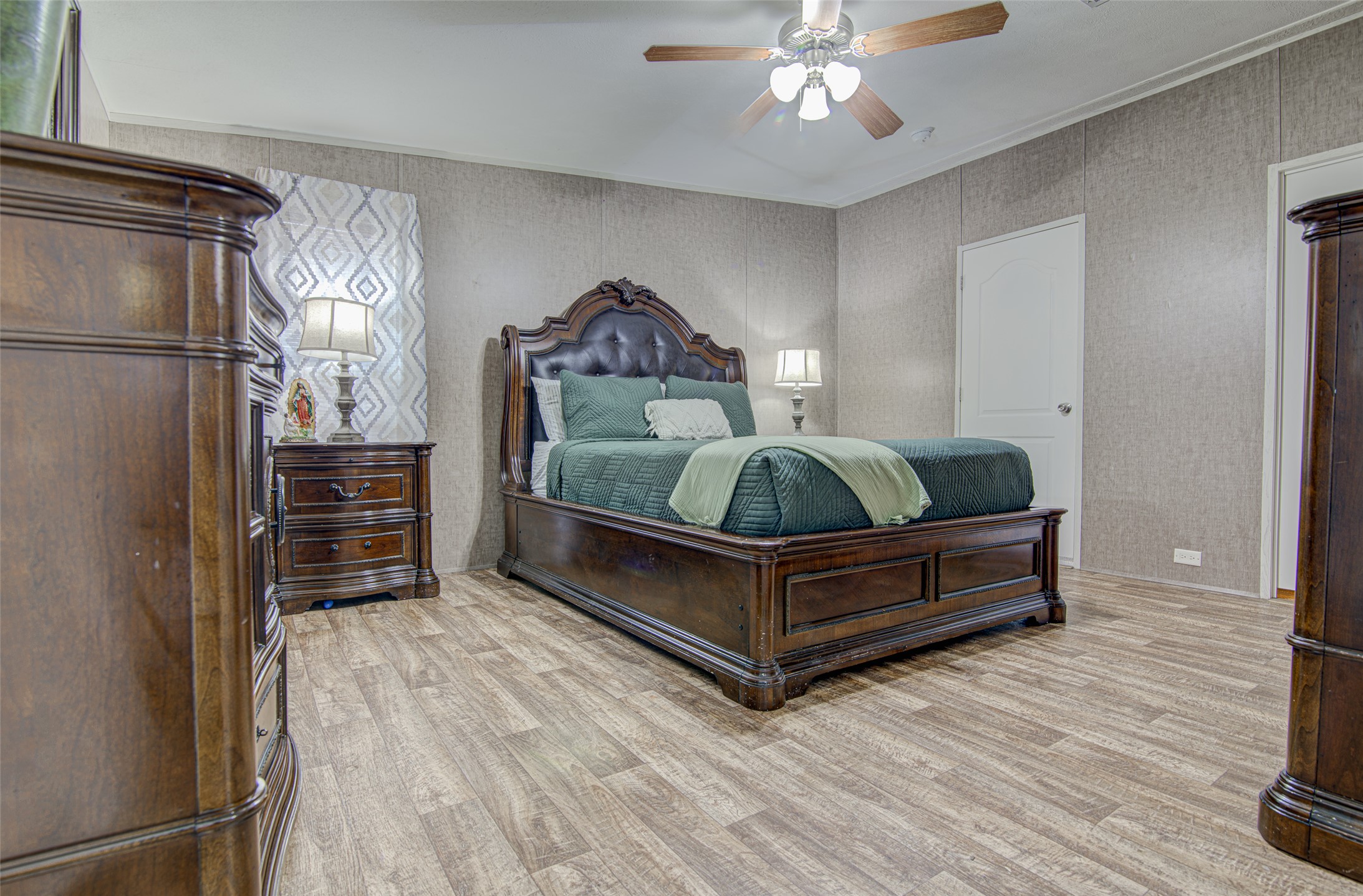 445 Rancho Linda Drive Lockhart, TX 78644 - Photo 16 of 26 Step into comfort with durable wood flooring and practical ceiling fan cooling in this inviting bedroom.
