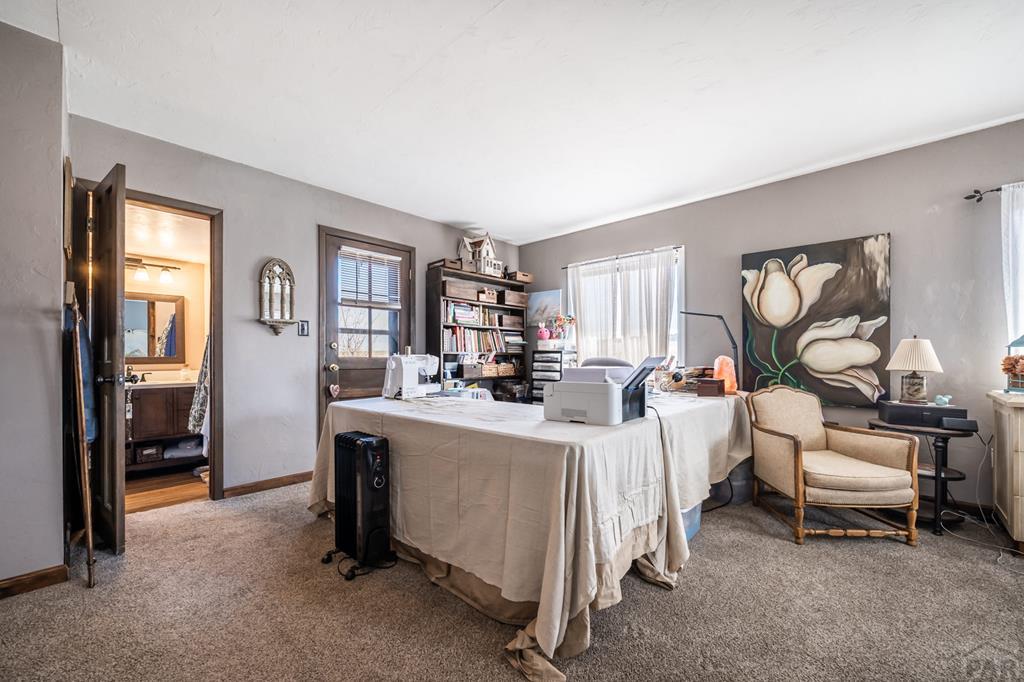 8419 3 R Road Beulah, CO 81023 - Photo 17 of 46 a living room with furniture a window and gym equipment