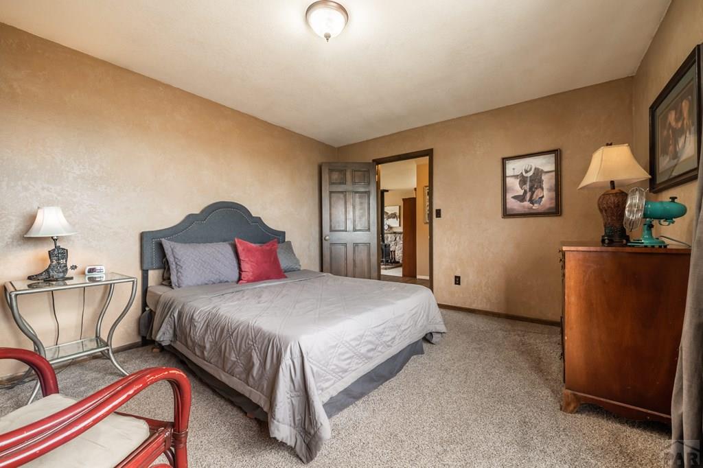 8419 3 R Road Beulah, CO 81023 - Photo 24 of 46 a bedroom with a bed and dresser