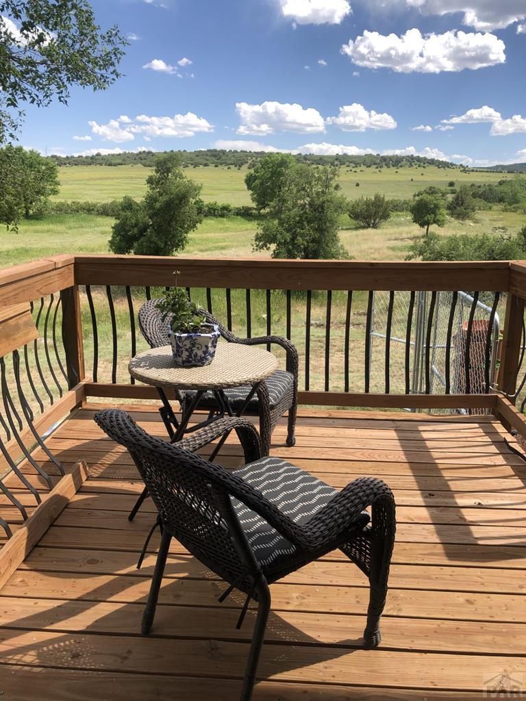 8419 3 R Road Beulah, CO 81023 - Photo 34 of 46 a view of a balcony with wooden chairs and city view