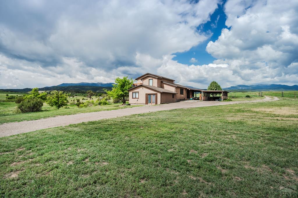 8419 3 R Road Beulah, CO 81023 - Photo 40 of 46 a view of a big house with a big yard and large trees