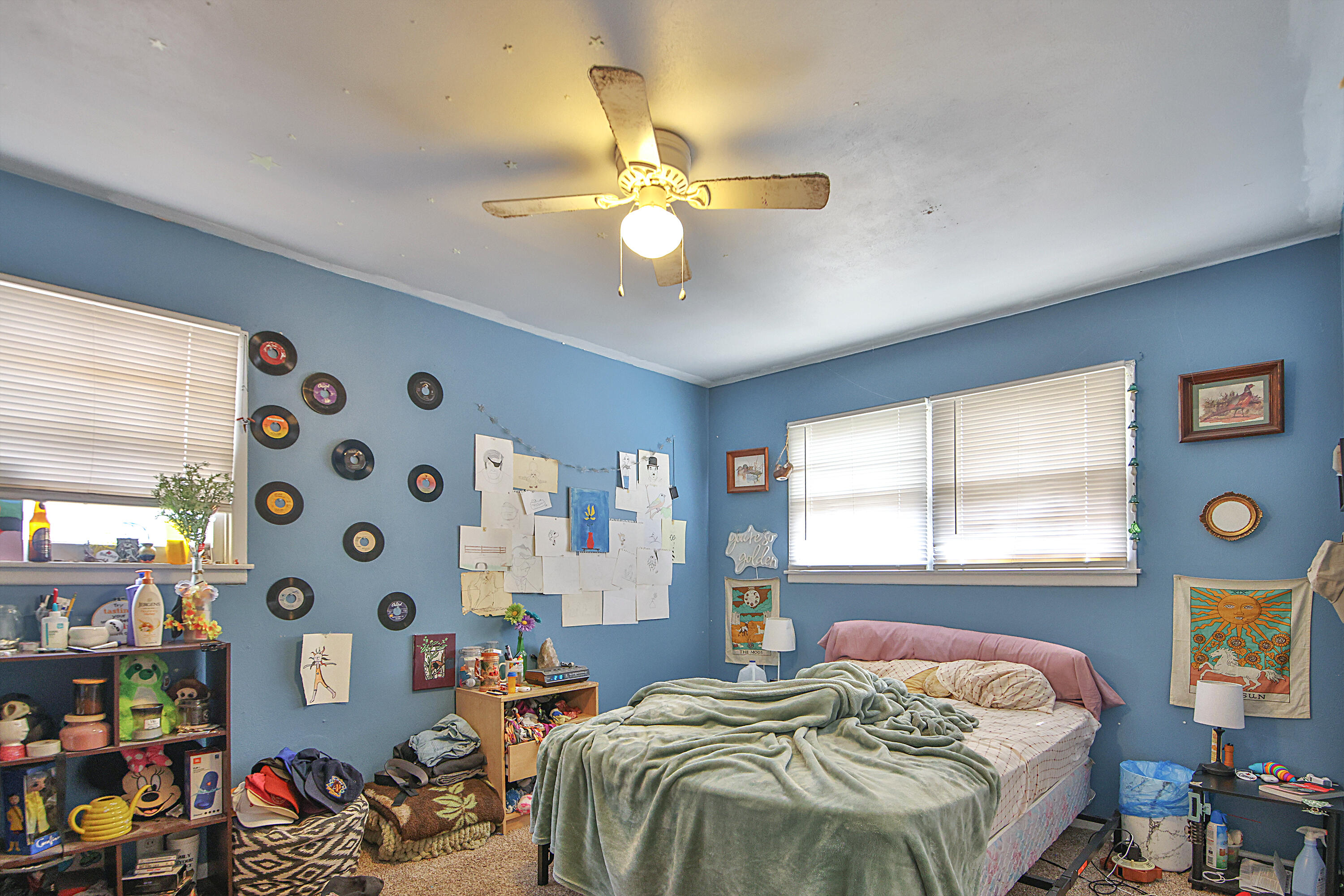4518 49th Street Lubbock, TX 79414 - Photo 18 of 32 a bedroom with a bed and a chandelier