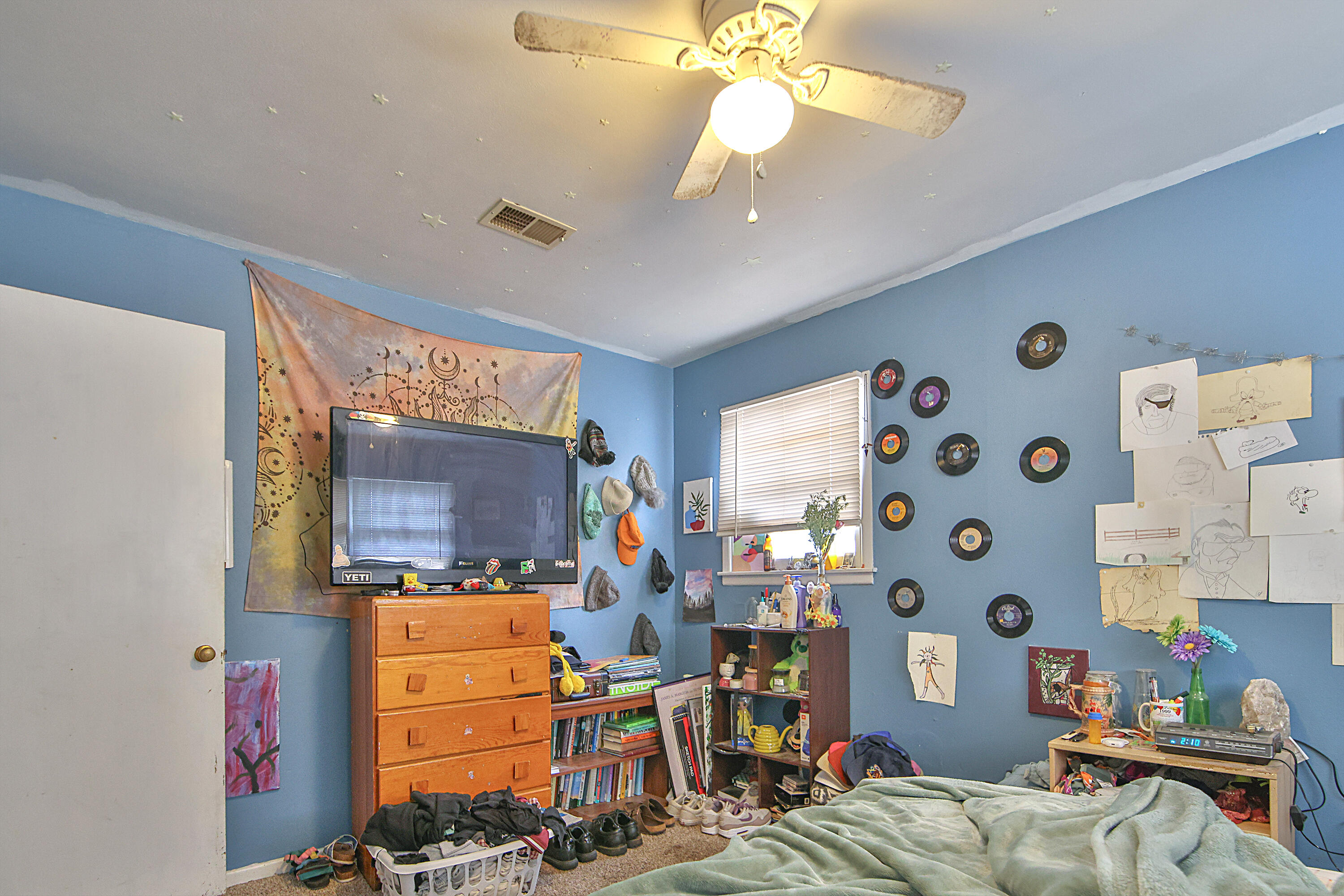 4518 49th Street Lubbock, TX 79414 - Photo 19 of 32 a bedroom with furniture and a flat screen tv