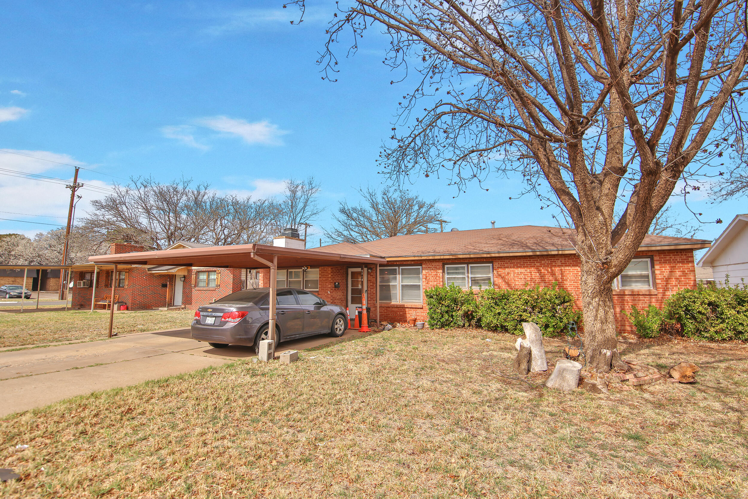 4518 49th Street Lubbock, TX 79414 - Photo 2 of 32 a view of a street with a cars parked in front of it
