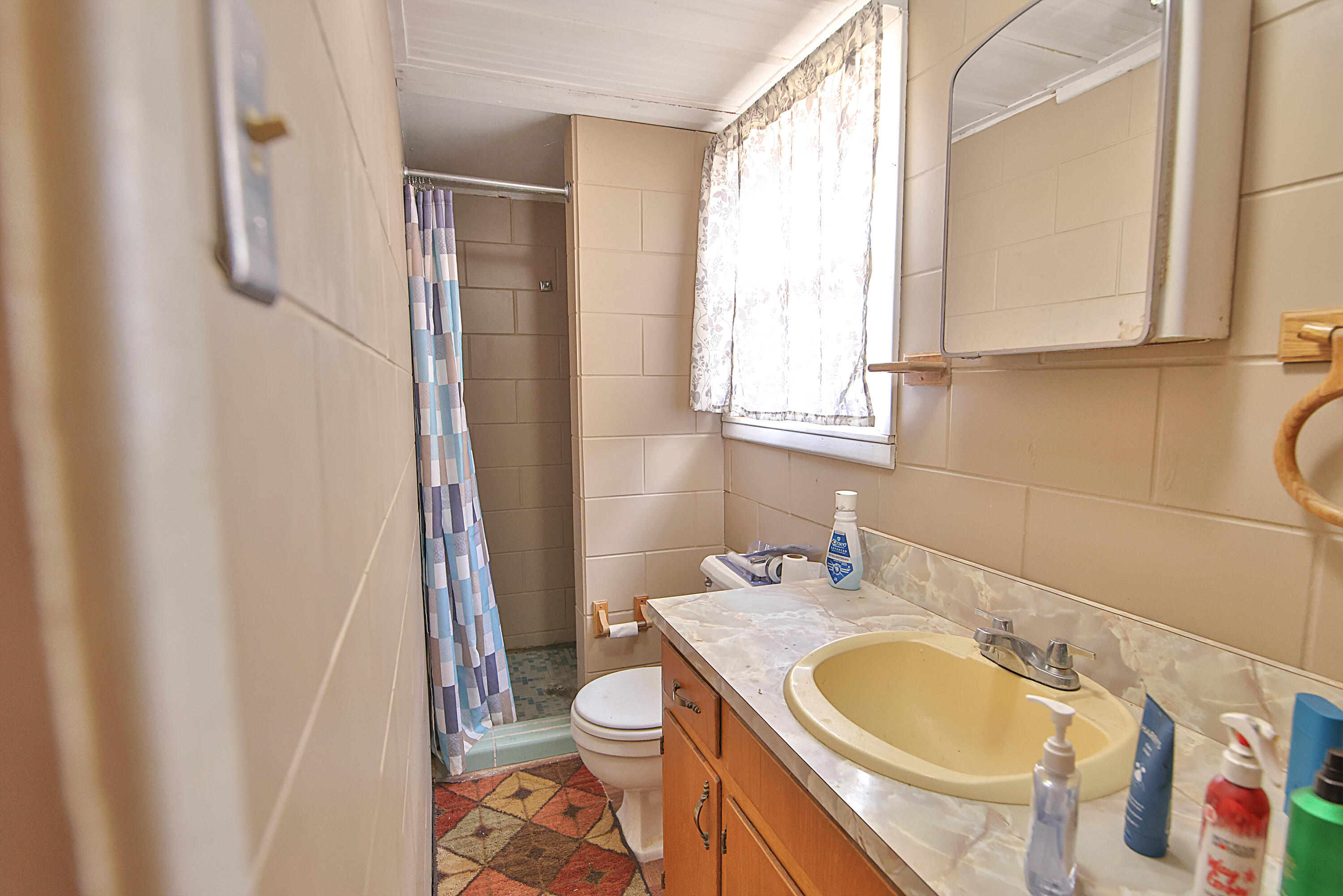 4518 49th Street Lubbock, TX 79414 - Photo 21 of 32 a bathroom with a granite countertop sink toilet and a mirror
