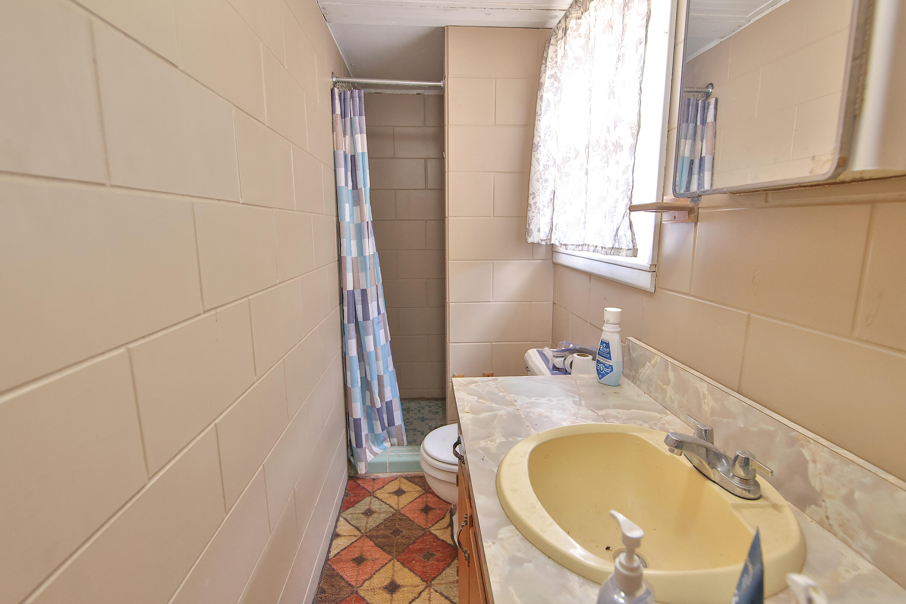 4518 49th Street Lubbock, TX 79414 - Photo 22 of 32 a bathroom with a granite countertop sink and a mirror