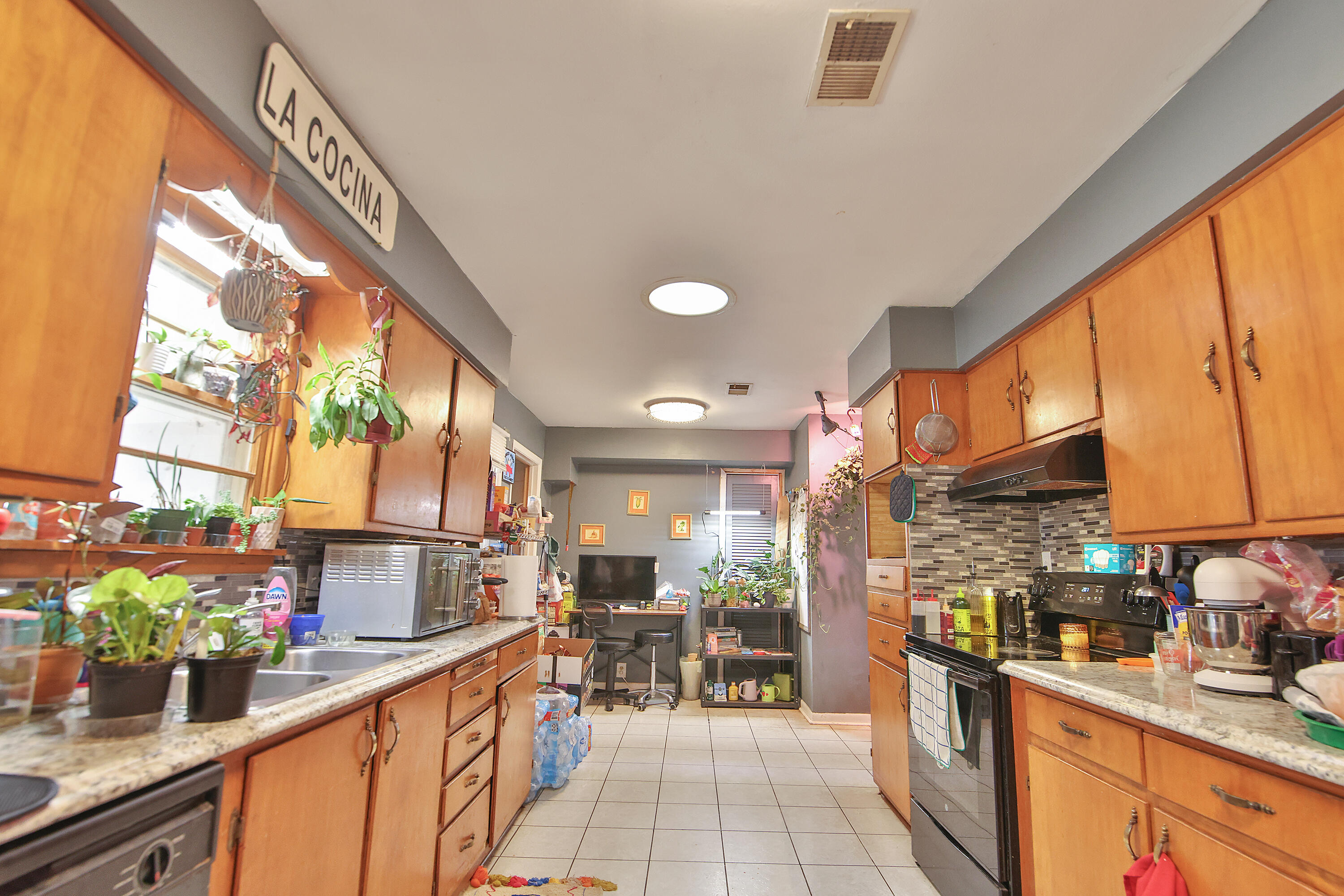 4518 49th Street Lubbock, TX 79414 - Photo 8 of 32 a kitchen with lots of counter top space and wooden floor