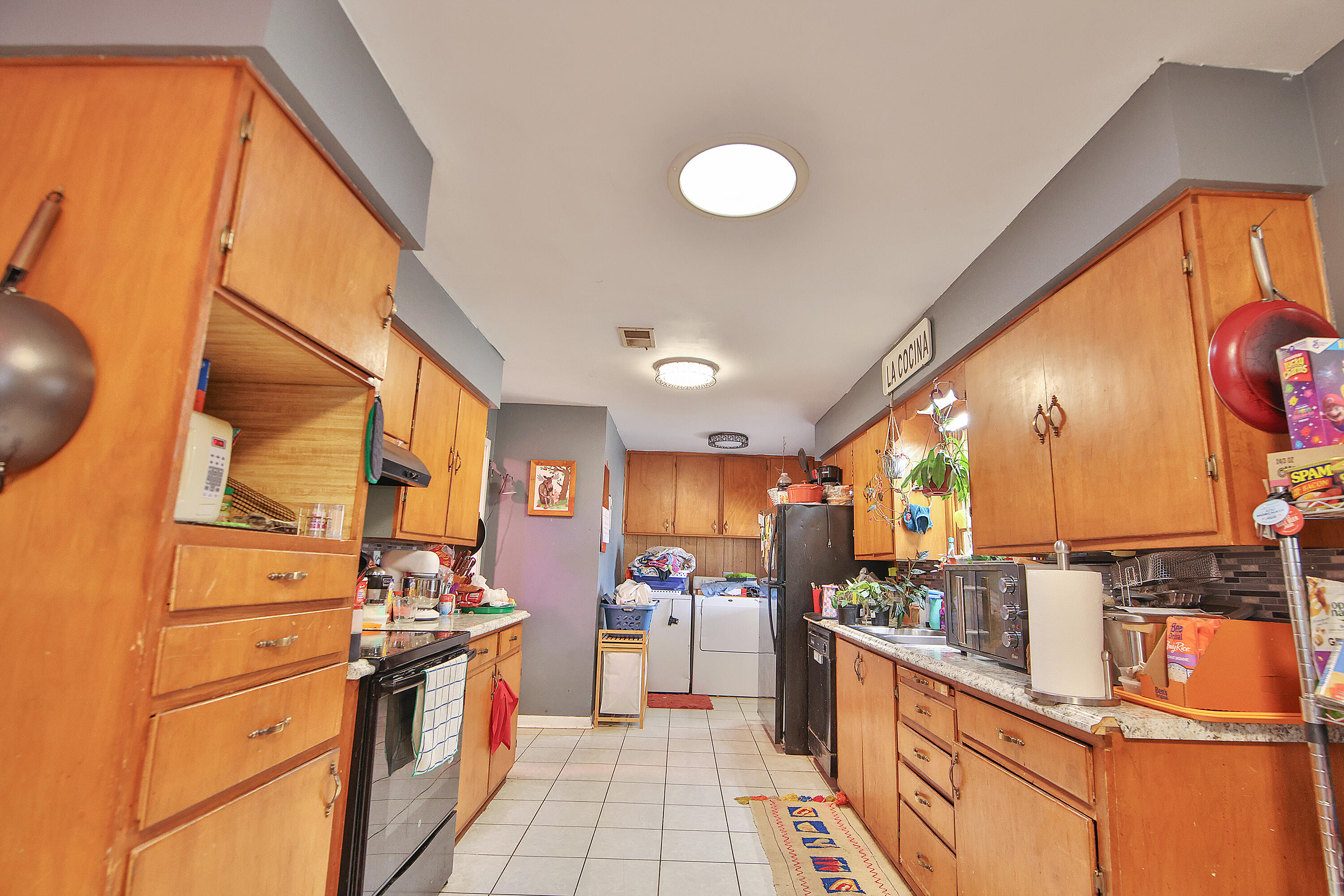 4518 49th Street Lubbock, TX 79414 - Photo 9 of 32 a kitchen with stainless steel appliances granite countertop a stove a sink and a refrigerator