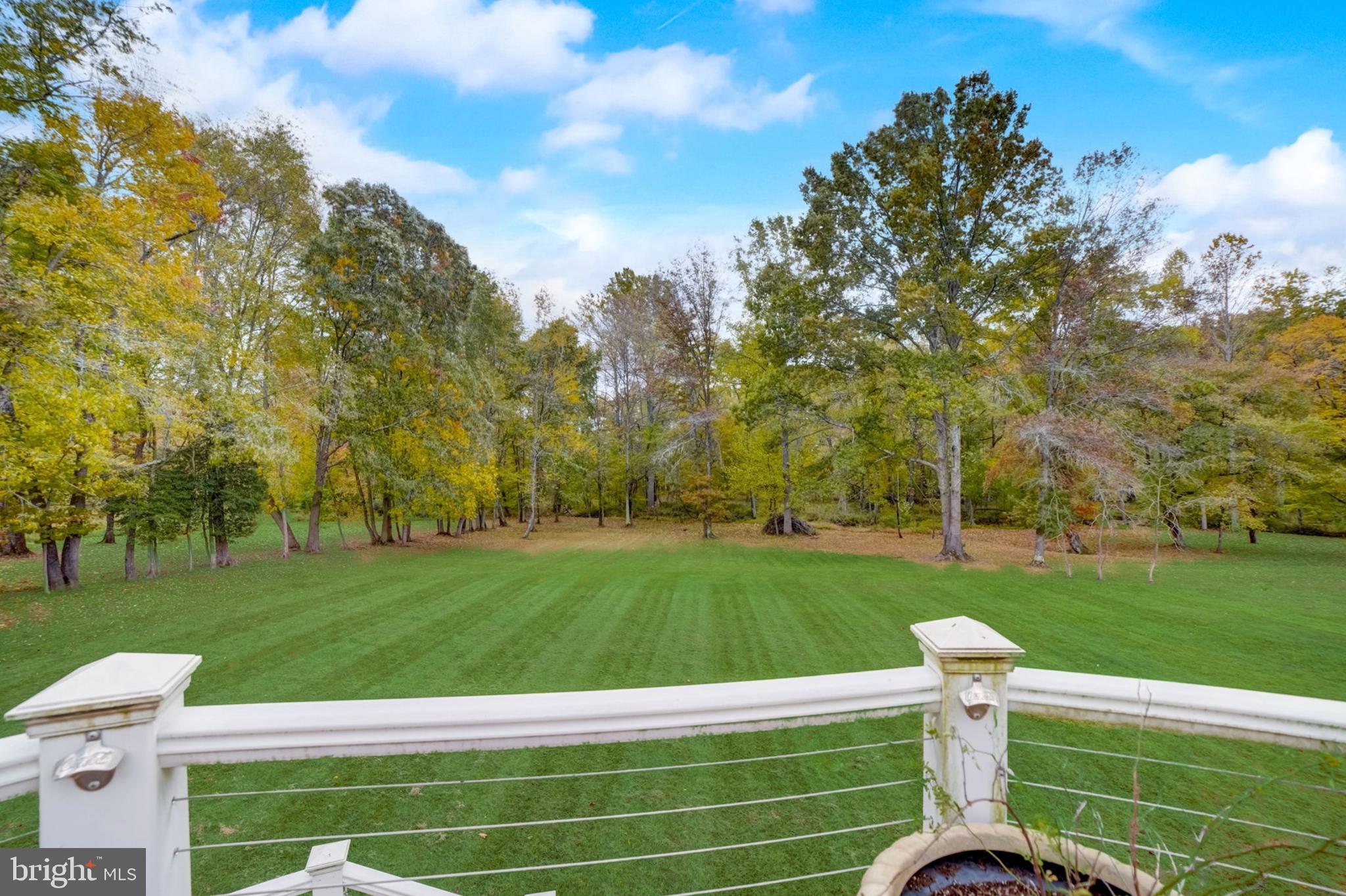 11561 Stuart Mill Road Oakton, VA 22124 - Photo 3 of 75 a view of a wooden deck and a big yard