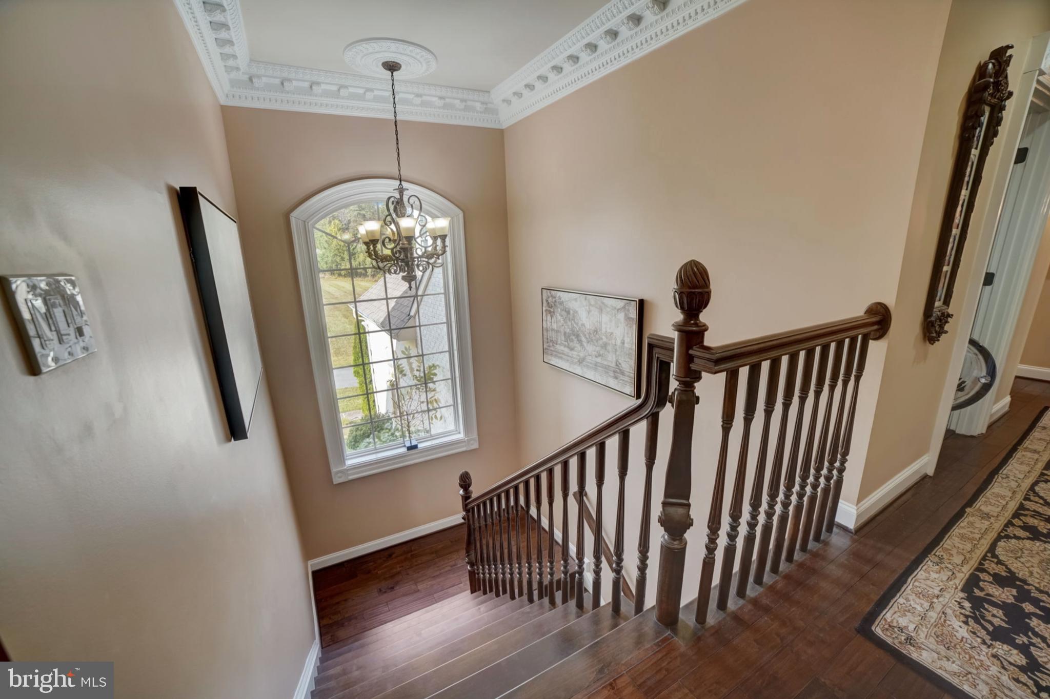 11561 Stuart Mill Road Oakton, VA 22124 - Photo 50 of 75 a view of a hallway with windows and chandelier