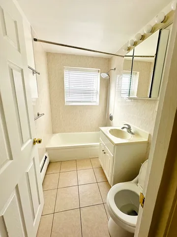 a bathroom with a bathtub and a toilet