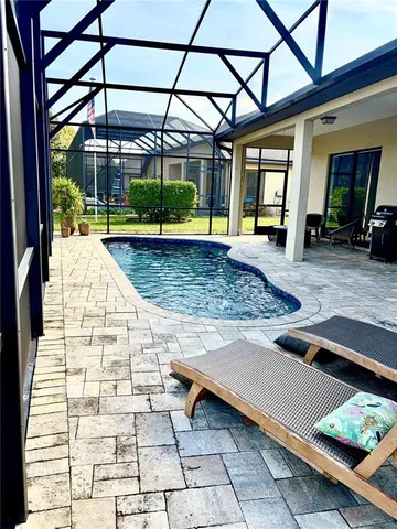 a view of a backyard with sitting area