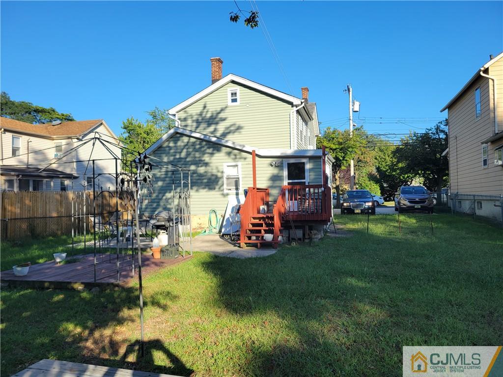 260 Raritan Street South Amboy, NJ 08879 - Photo 3 of 10 a view of a house with a big yard potted plants and large trees