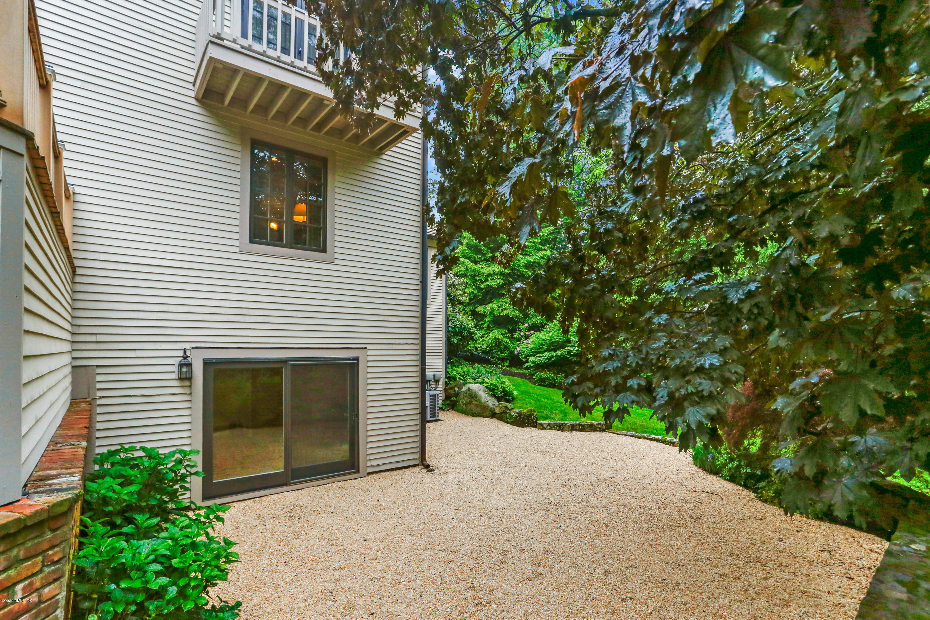 65 Ridgeview Avenue Greenwich, CT 06830 - Photo 39 of 50 a yellow house with trees in front of it