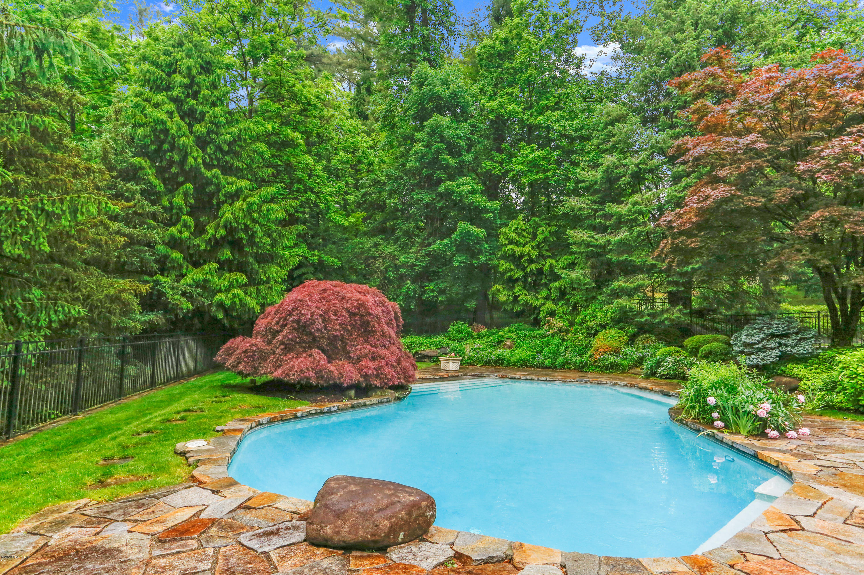 65 Ridgeview Avenue Greenwich, CT 06830 - Photo 40 of 50 a view of a backyard with table and chairs potted plants and wooden fence