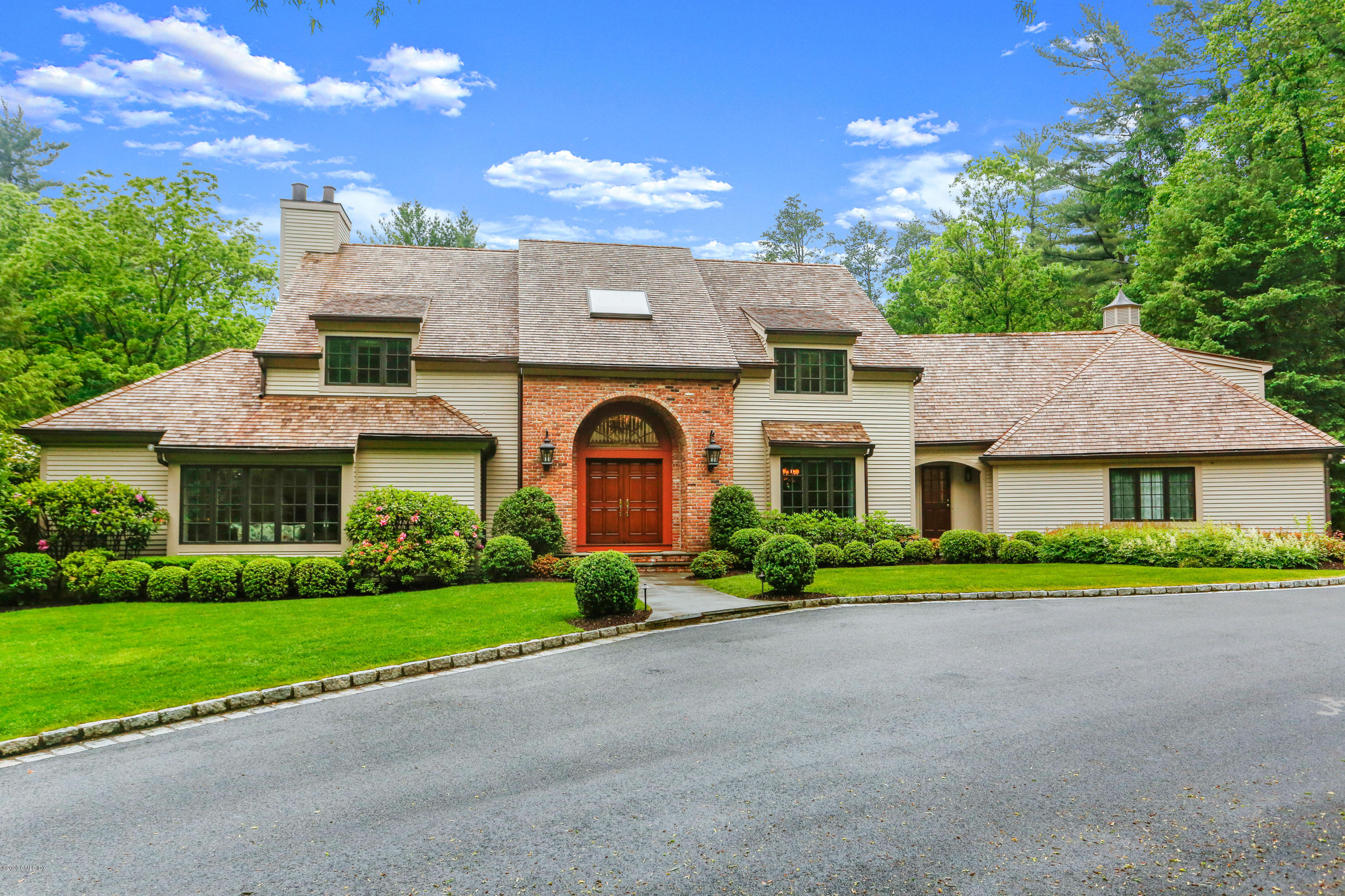 65 Ridgeview Avenue Greenwich, CT 06830 - Photo 46 of 50 a front view of a house with a garden