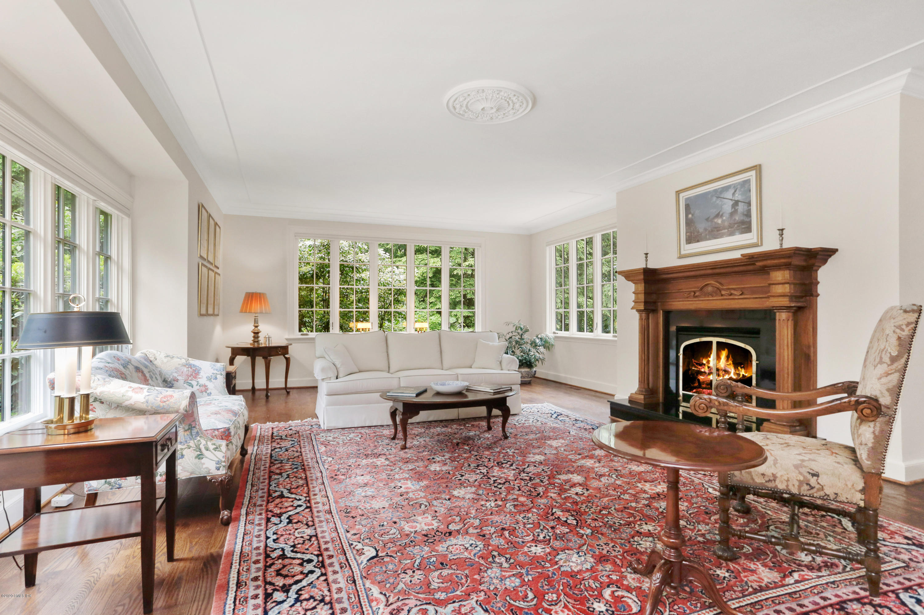 65 Ridgeview Avenue Greenwich, CT 06830 - Photo 6 of 50 a living room with furniture a rug a fireplace and a large window