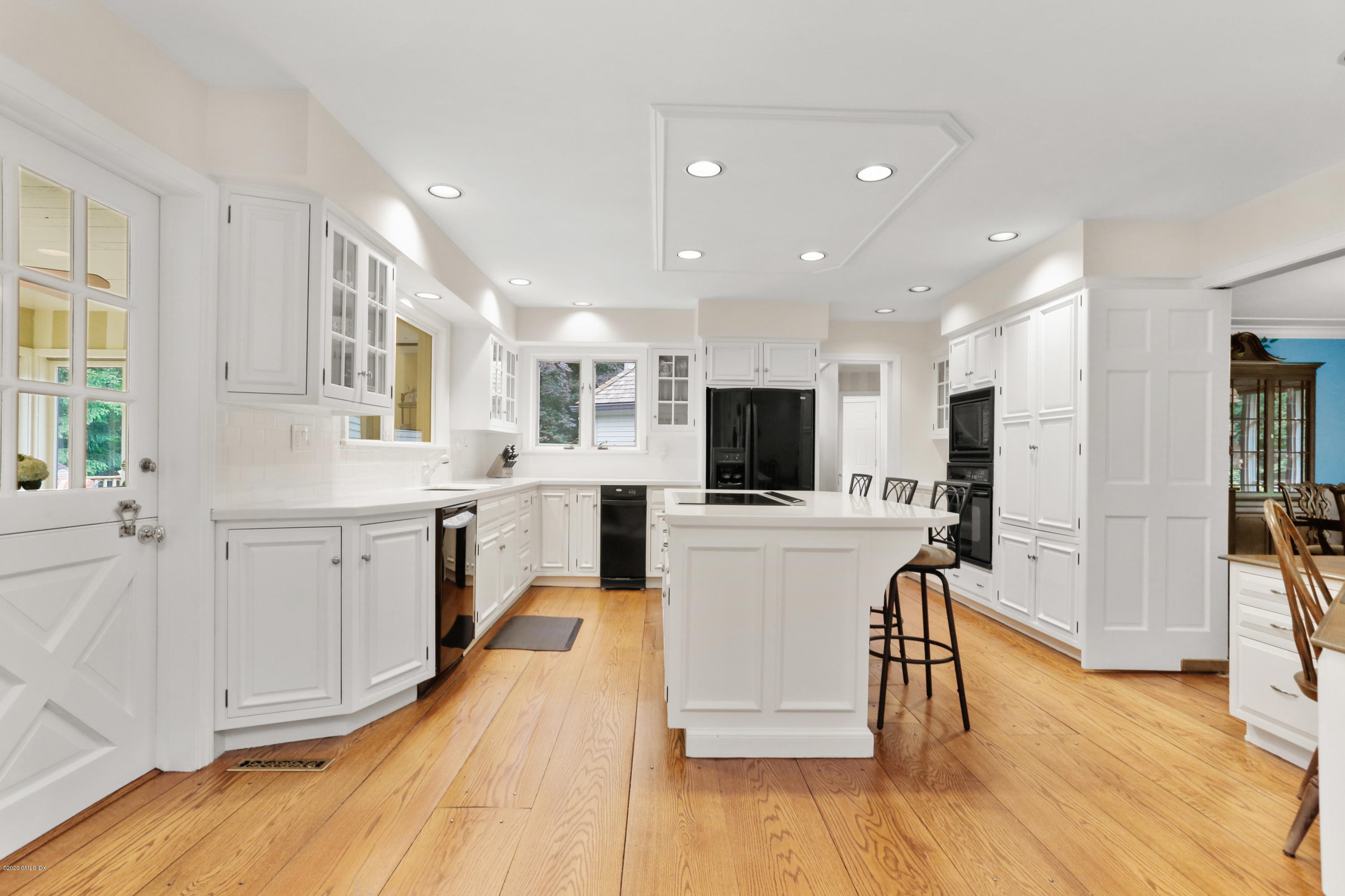 65 Ridgeview Avenue Greenwich, CT 06830 - Photo 10 of 50 a kitchen with white cabinets and stainless steel appliances