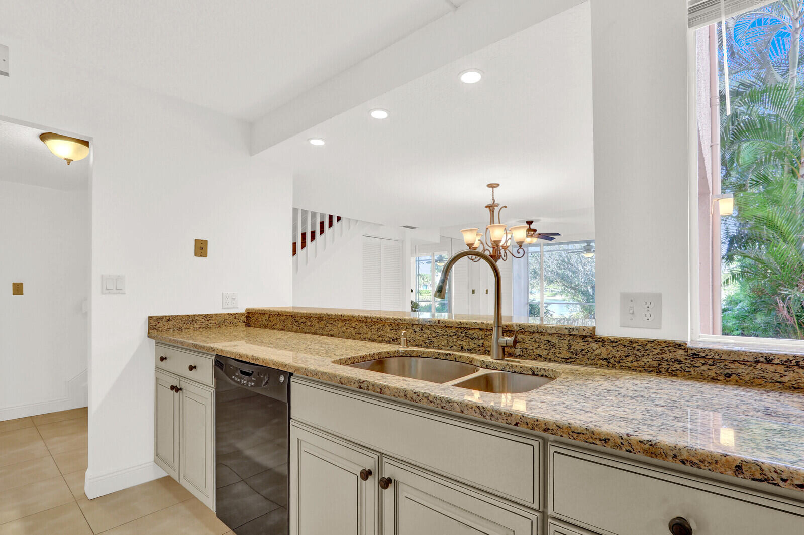 353 Highway 1, Unit D105 Jupiter, FL 33477 - Photo 16 of 56 a sink with a granite countertop sink and a mirror
