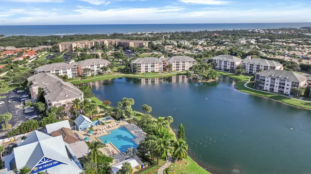 an aerial view of residential houses with outdoor space and swimming pool