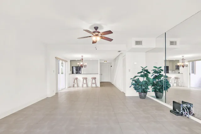 a view of living room with furniture and a chandelier