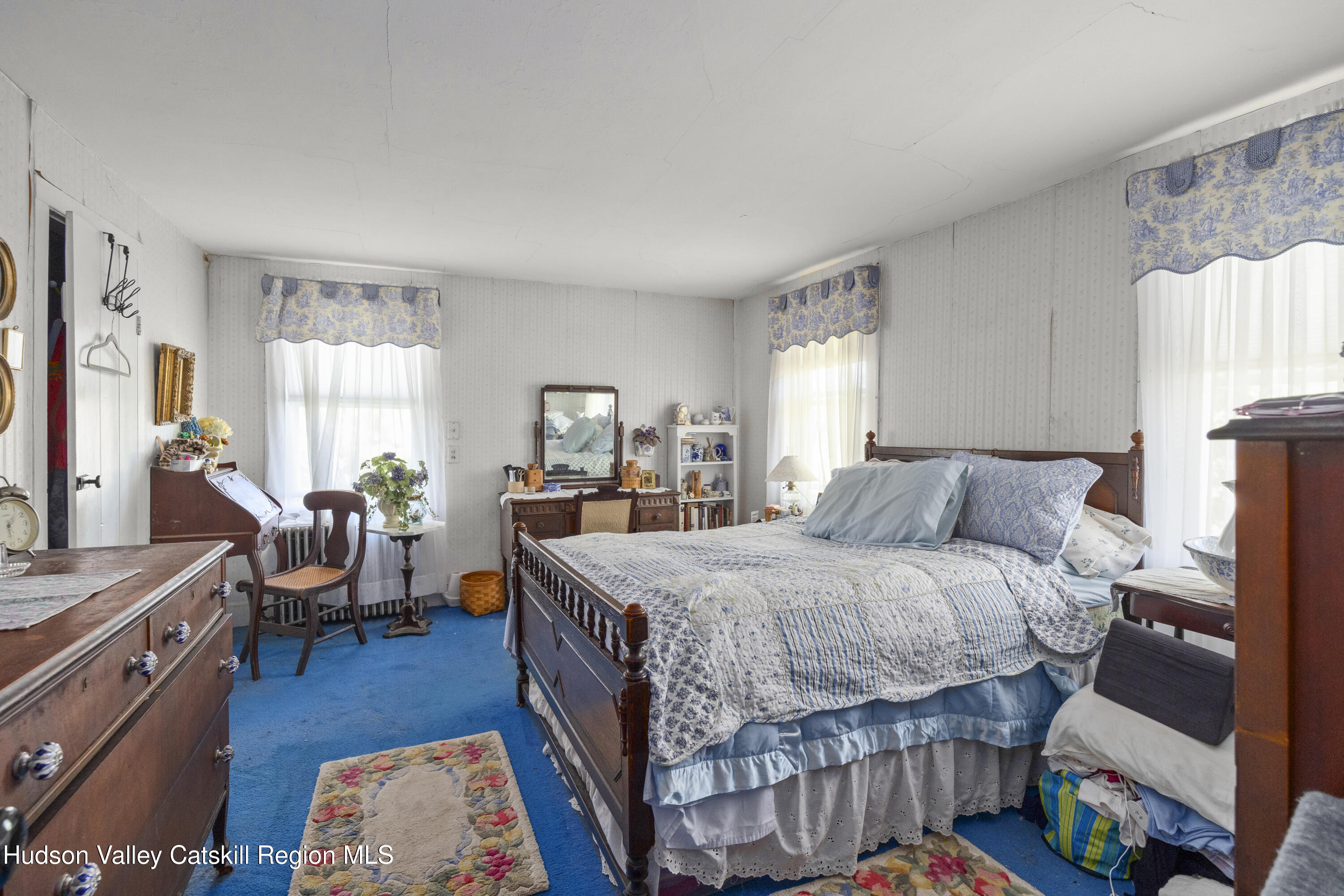 1745 County Route 7 Ancram, NY 12502 - Photo 15 of 22 a bedroom with a bed and a wooden floor