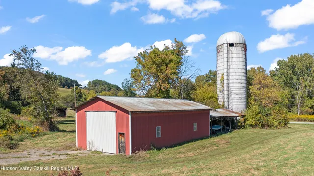 a view of a house with a yard and sitting area
