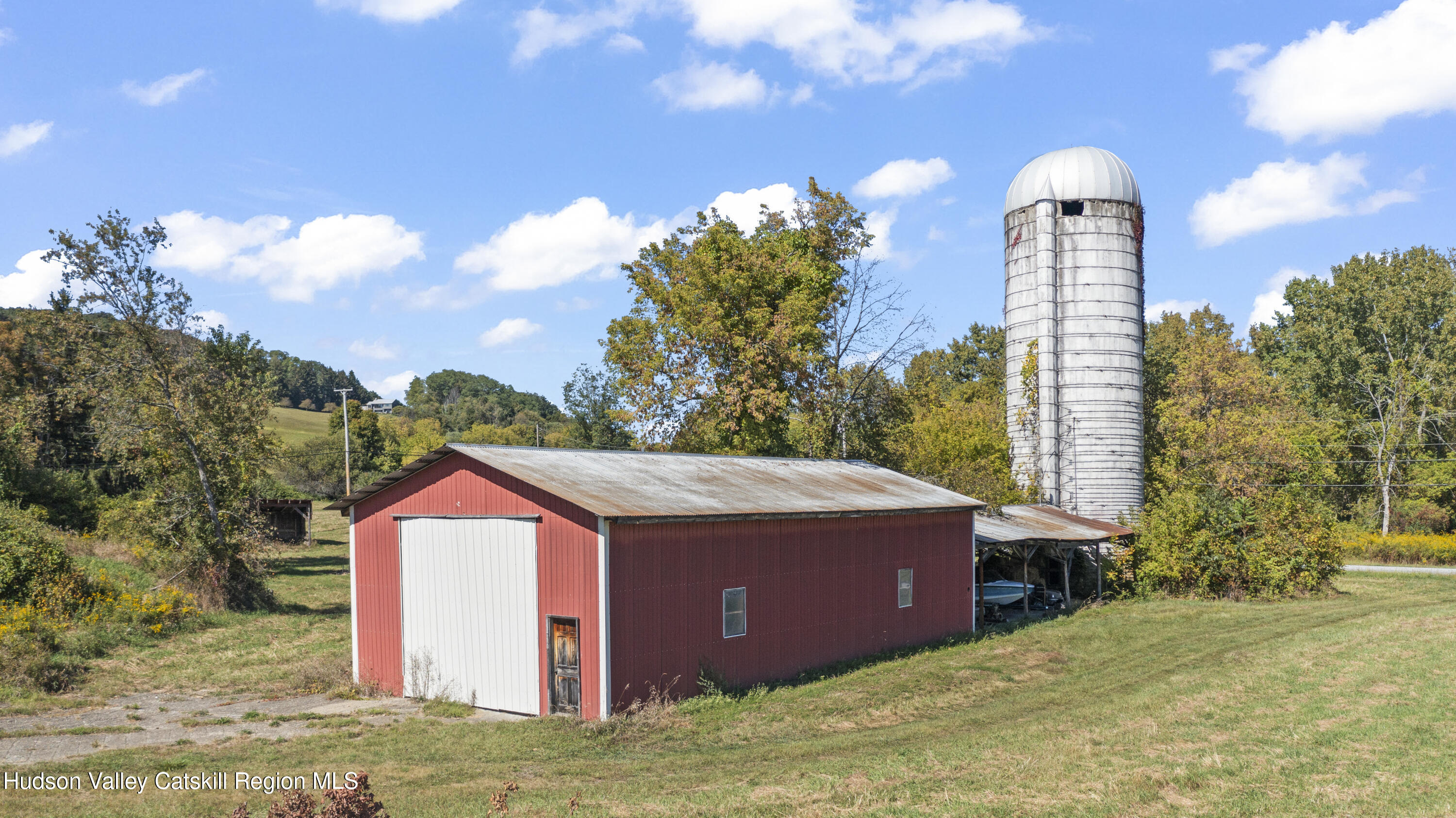 1745 County Route 7 Ancram, NY 12502 - Photo 17 of 22 a front view of a house with a yard and garage