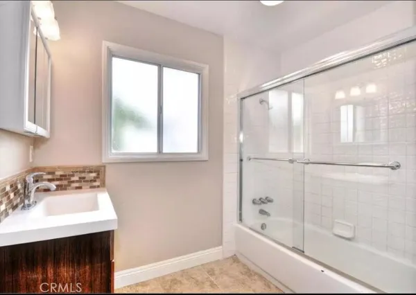 a bathroom with a bathtub and a sink