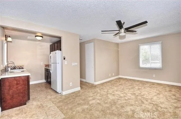 a view of a livingroom with a ceiling fan and window