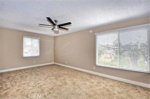 a view of a livingroom with a ceiling fan and window