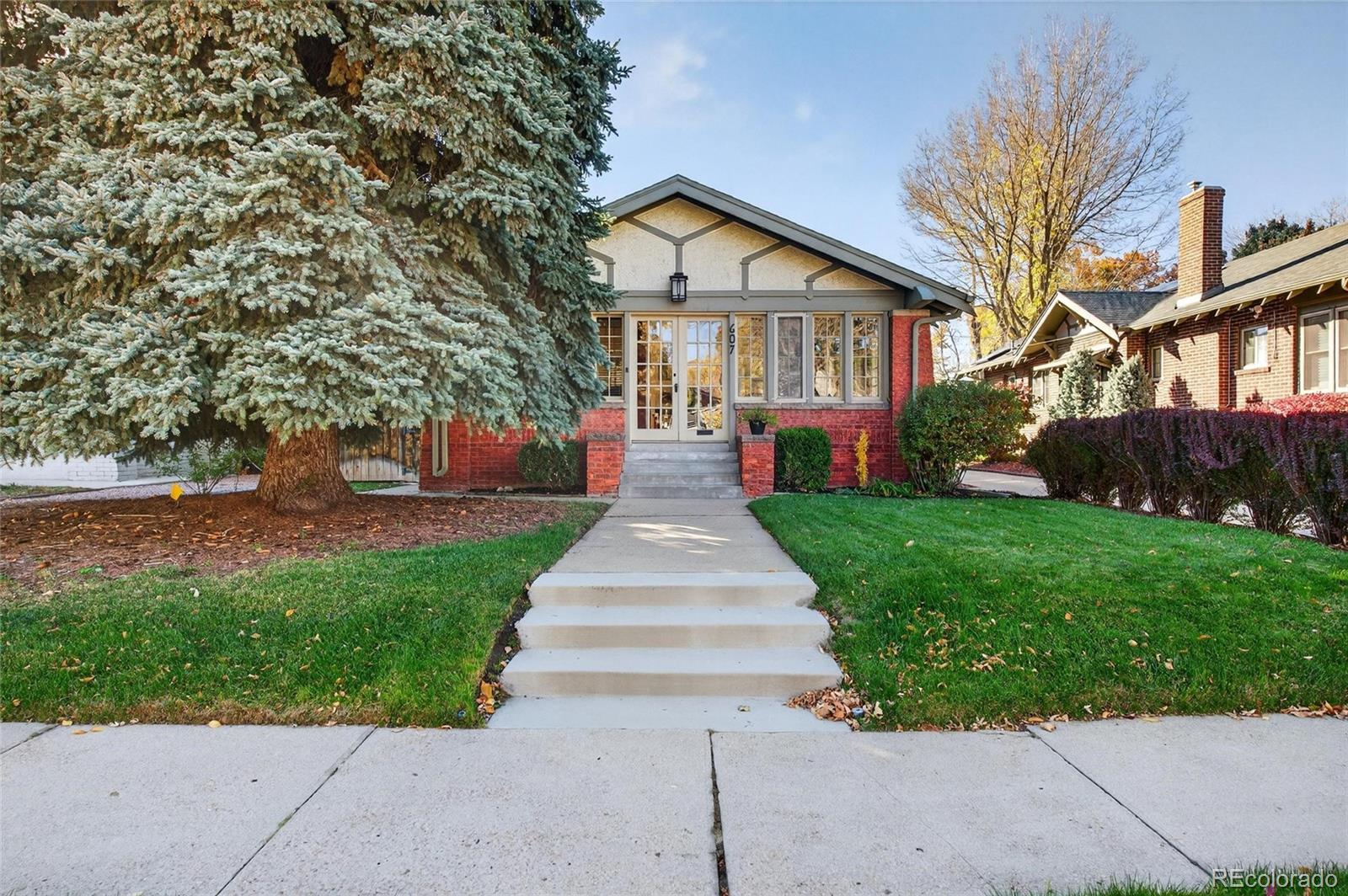 607 Madison Street Denver, CO 80206 - Photo 1 of 31 a front view of a house with garden