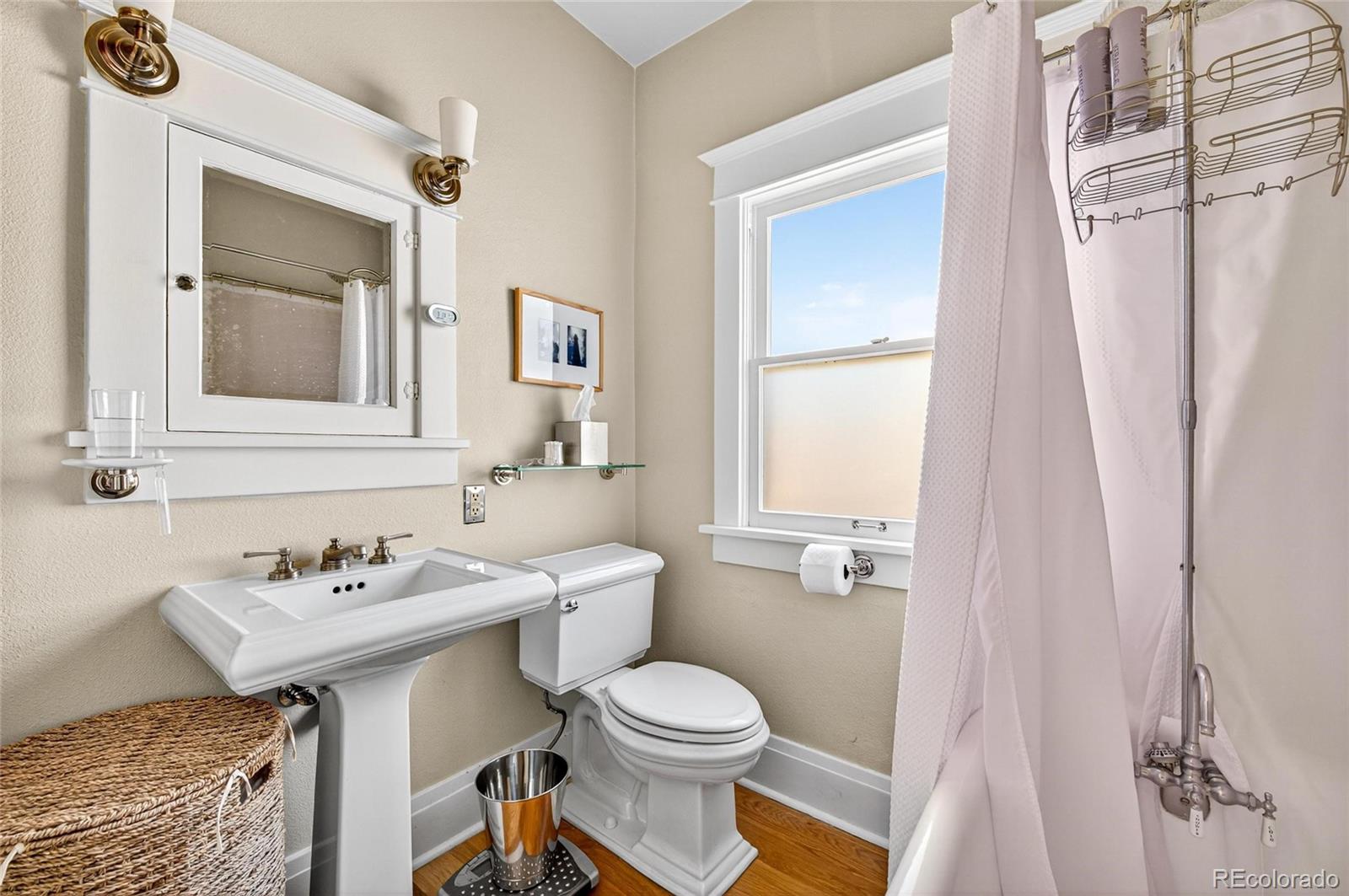 607 Madison Street Denver, CO 80206 - Photo 11 of 31 a bathroom with a sink toilet and a mirror