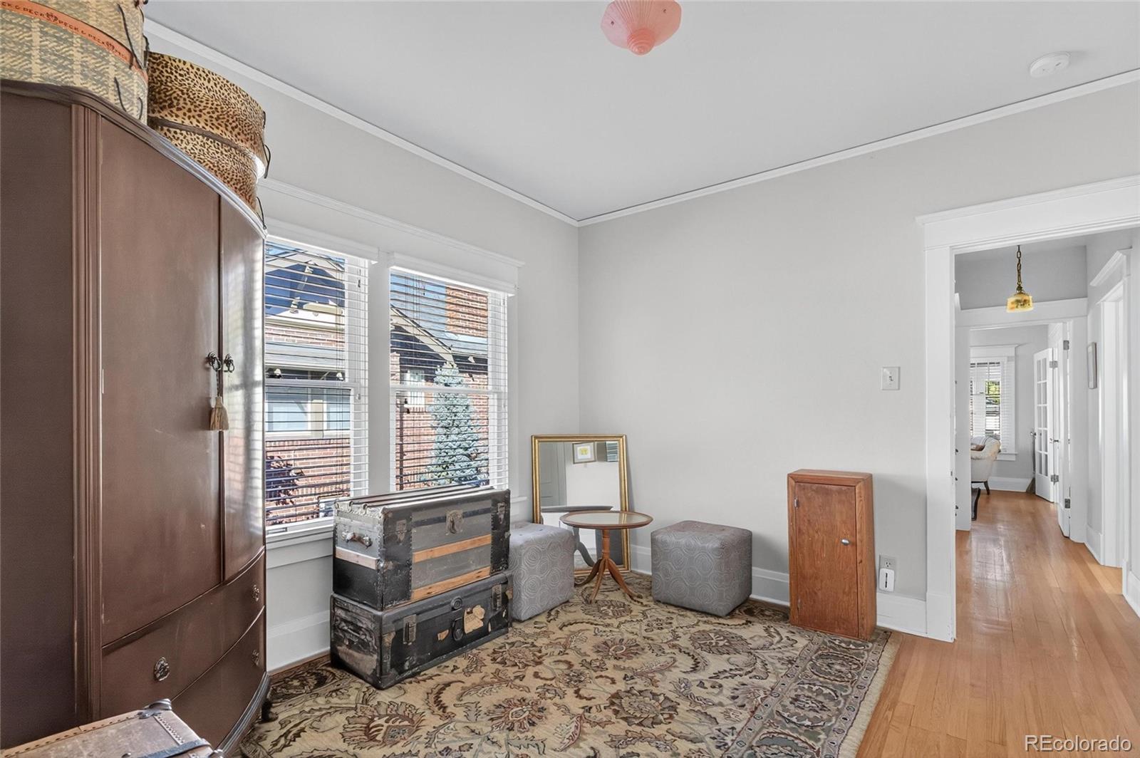 607 Madison Street Denver, CO 80206 - Photo 13 of 31 a bedroom with furniture and a window