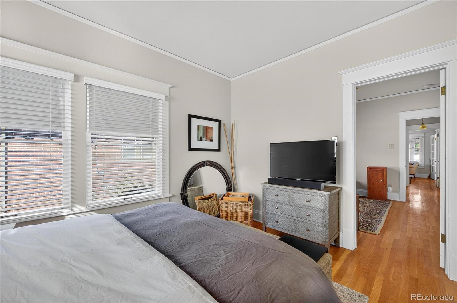 607 Madison Street Denver, CO 80206 - Photo 15 of 31 a bedroom with a bed and a flat screen tv