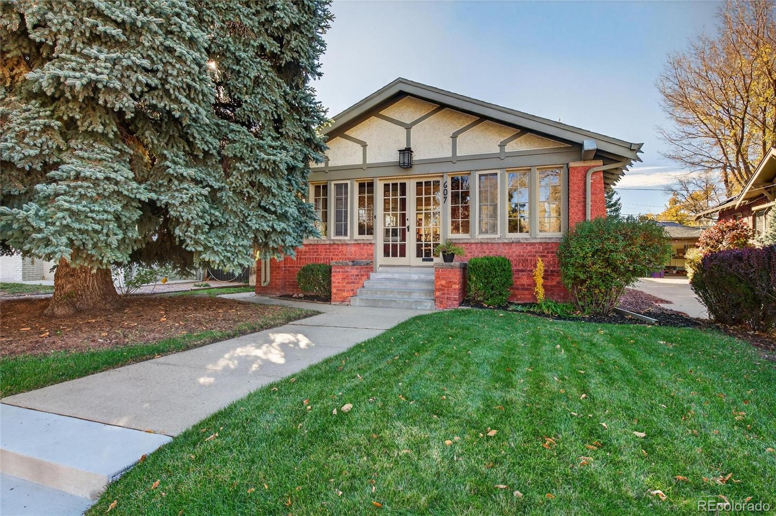 607 Madison Street Denver, CO 80206 - Photo 2 of 31 a view of a house with backyard sitting area and garden