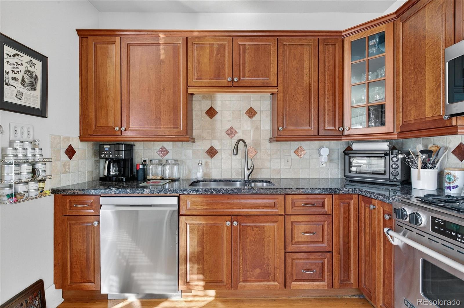 607 Madison Street Denver, CO 80206 - Photo 21 of 31 a kitchen with stainless steel appliances granite countertop a stove top oven a sink dishwasher and cabinets with wooden floor