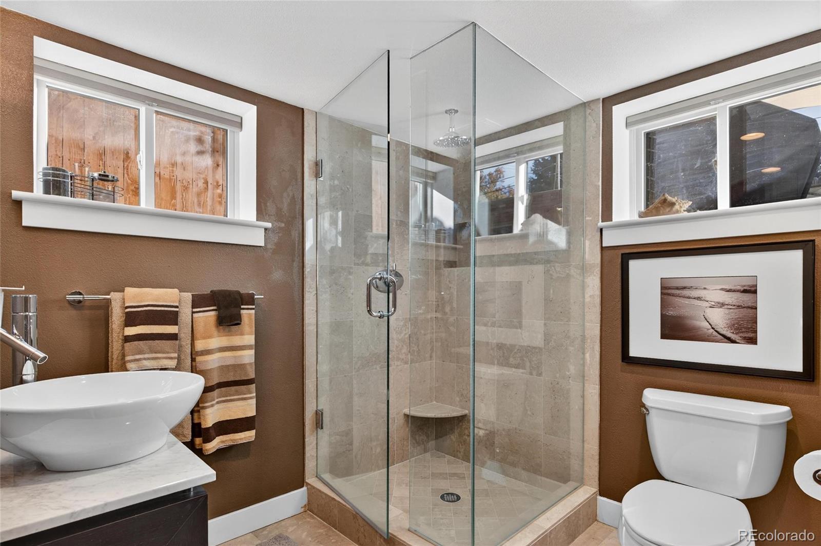 607 Madison Street Denver, CO 80206 - Photo 29 of 31 a bathroom with a toilet sink and shower