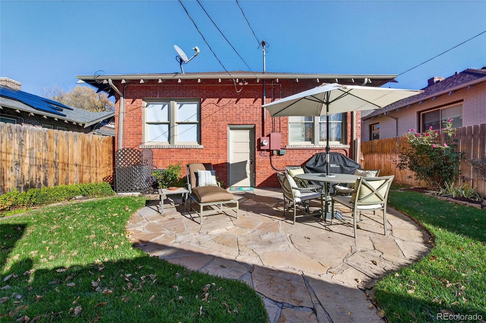 607 Madison Street Denver, CO 80206 - Photo 31 of 31 a view of a house with backyard porch and sitting area