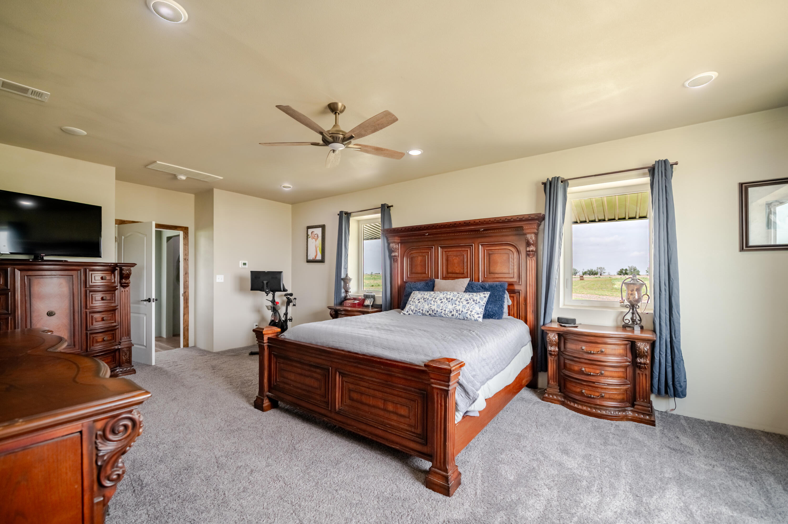 6792 Maine Road Anton, TX 79313 - Photo 25 of 77 a bedroom with a bed and a flat screen tv