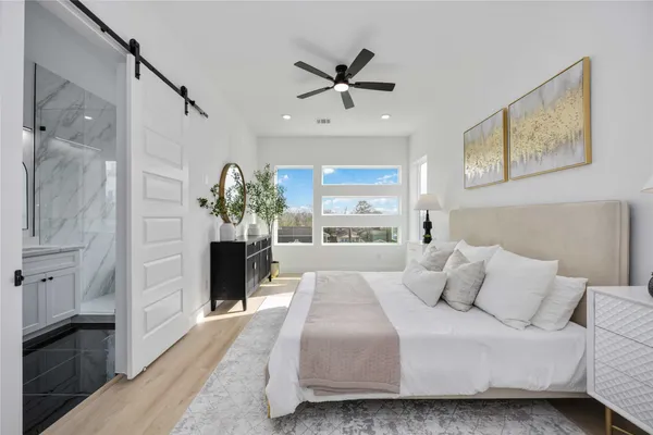 a bed room with a bed and a ceiling fan